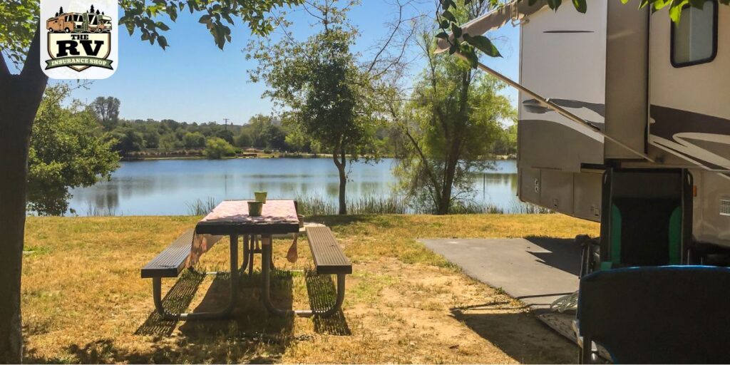 an RV parked at a campsite, belonging to someone who's thinking about the various types of RV insurance they need.